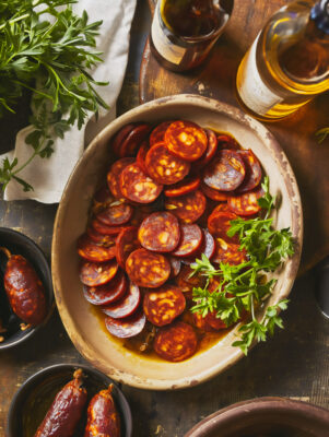 Sliced Chorizo and Cider in a Vintage Earthenware Dish